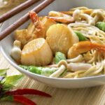 Fried noodles with prawns and scallops, curry and coconut milk