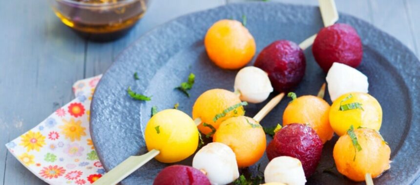 Skewers of multicolored marbles and balsamic syrup
