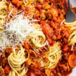 Classic spaghetti bolognese with mushrooms and cheese