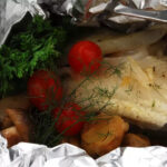 Hake on a bed of vegetables en papillote