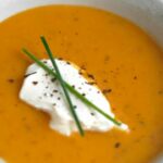 Pumpkin soup with chanterelle mushrooms and whipped cream with mustard