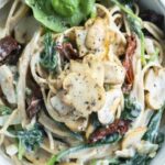 Veggie spaghetti carbonara with dried tomatoes, spinach and mushrooms