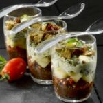 Verrines of candied tomatoes and olives with Emmental cheese