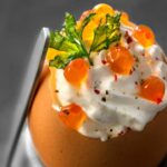Scrambled eggs with herbs, whipped cream with salmon eggs