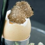 Soft-boiled eggs with truffles and asparagus fingers
