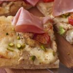 Thin pizza with artichoke hearts and mortadella