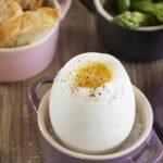 Soft-boiled goose egg with green asparagus