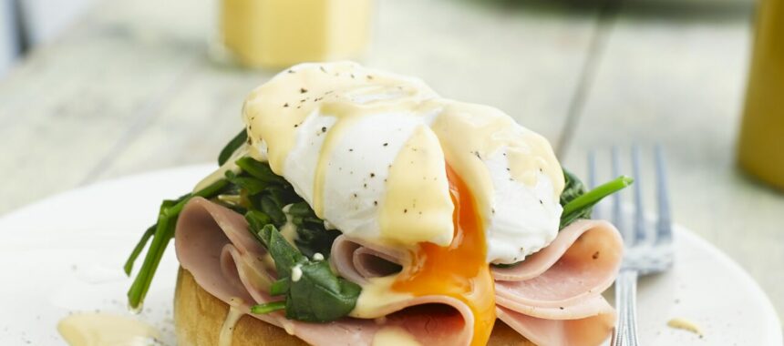 Eggs Benedict with ham and basil