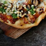 Pizza with egg mozzarella mushrooms and pine nuts