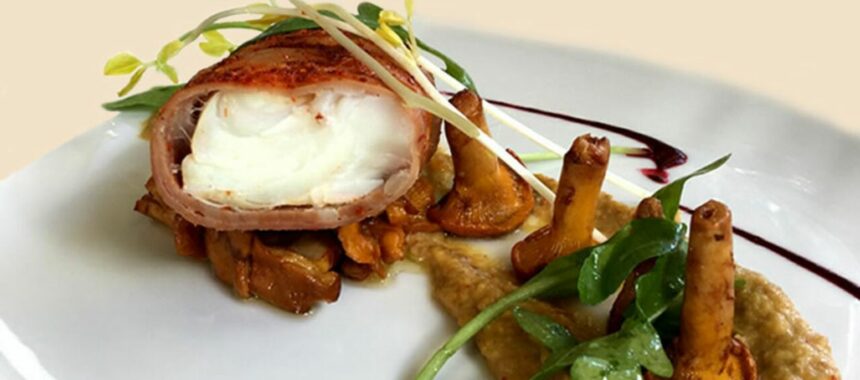Ballotine of cod fillet with parma ham and artichoke cream with chanterelle mushrooms