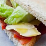 Club sandwich with cheese, tomato lettuce and thin slices of bresaola